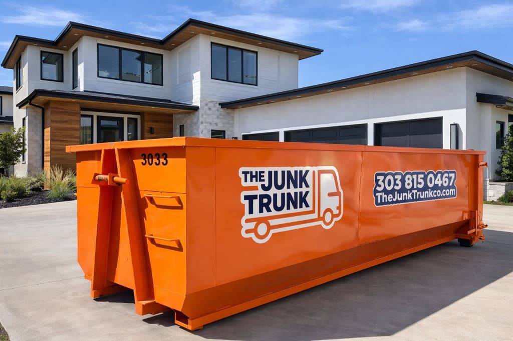 Branded Junk Trunk roll-off dumpster on a residential driveway