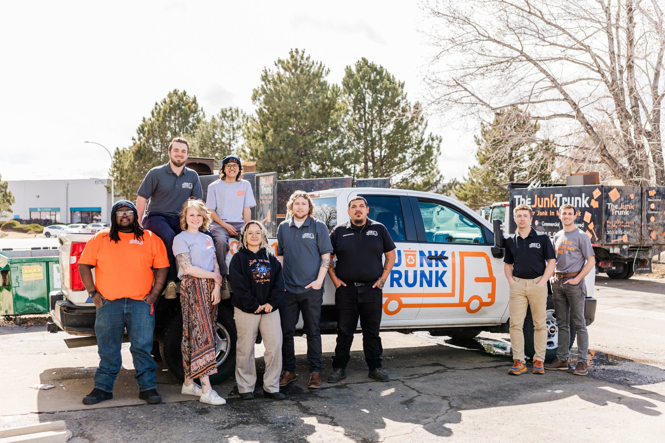 The Junk Trunk team gathered around a branded truck